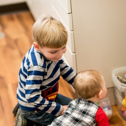 Two children playing with toys in dental office