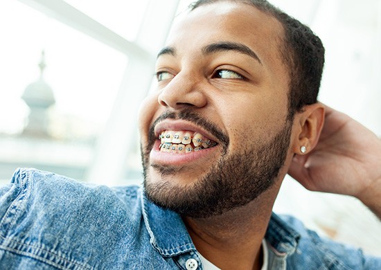 Smiling adult man with braces