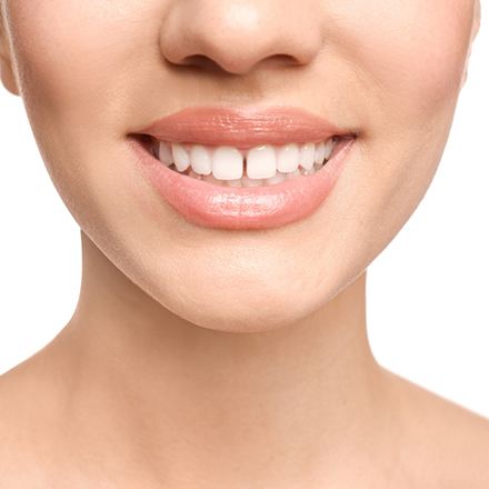 Person with a gap between their upper front two teeth