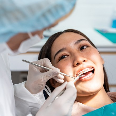 Young girl having her teeth and braces checked regularly