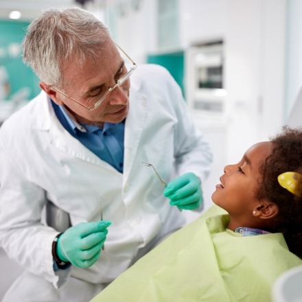 Dentist treating child after dental emergency