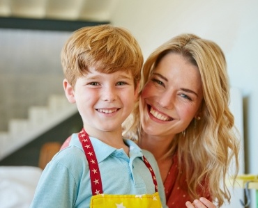 Mother and child smiling after emergency dentistry