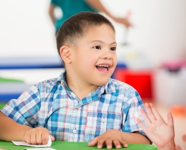 Young child smiling after special needs dentistry visit