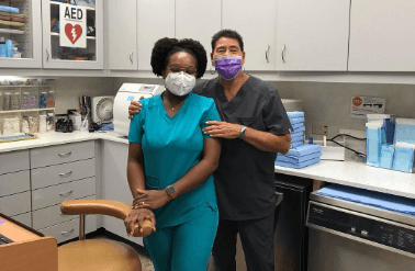 Two pediatric dental team members in dental office lab and storage area