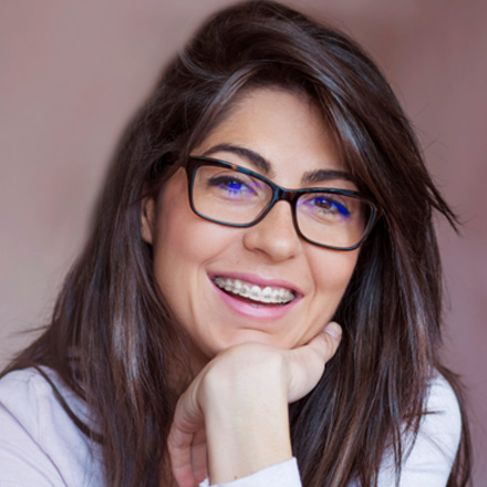 Female wearing braces and smiling