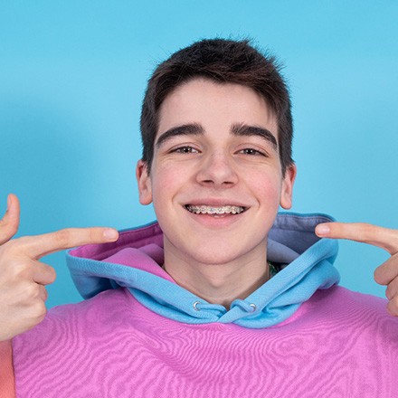 Close-up of young person’s smile with clear braces