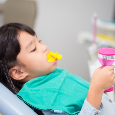 Child receiving silver diamine fluoride treatment