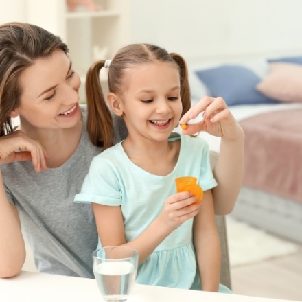 Mother giving child oral conscious dental sedation pill