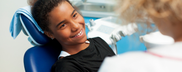 Child smiling during preventive dentistry visit