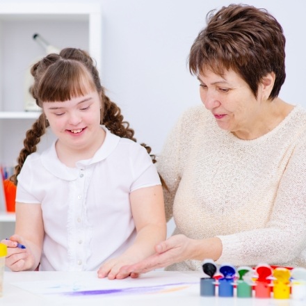 Mother and child painting after special needs dentistry