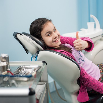 child with special needs thumbs up after special needs dentistry in Glen Ellyn