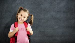 happy kid with good oral health and good academic performance