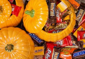 ceramic pumpkin dishes full of Halloween candy