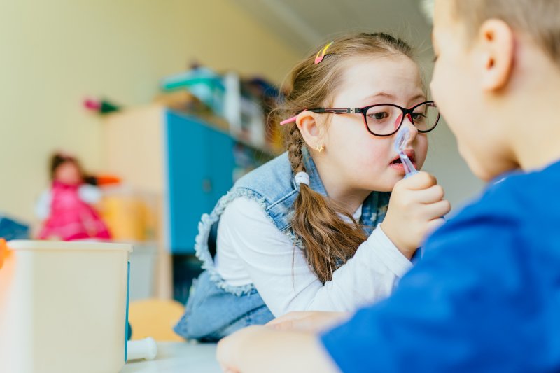 A special needs girl playing at the dentist after her oral health was taken care of