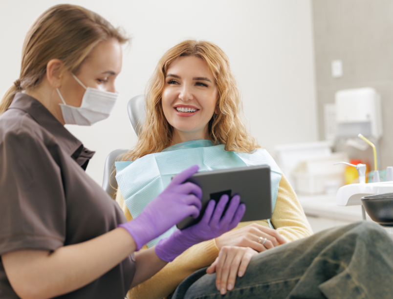 Dentist showing patient tablet screen